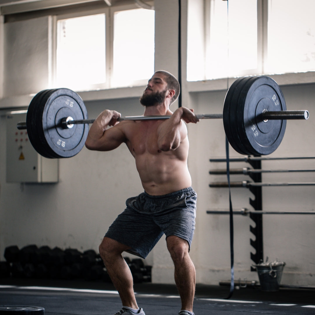 Man lifting a barbell in a gym setting